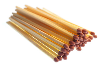 Close-up of long matchsticks on a white background