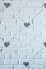 Drawing of gray lines and hearts on a white brick wall, background or concept
