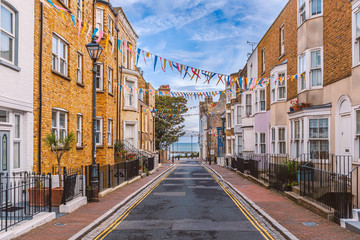 A view along Addington Street, Ramsgate toward the sea. Bunting is flying in preparation for the annual street fair. The street is part of Ramsgate's burgeoning music and art scene. - obrazy, fototapety, plakaty