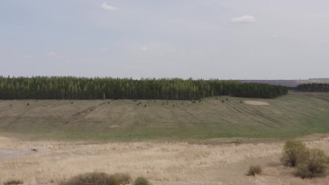 Aerial survey of arable land. Plowed field. Fertile land of arable land. Sowing. Fly over the arable land.