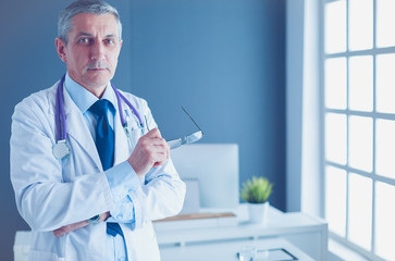 Portrait of a smiling doctor in his bright office