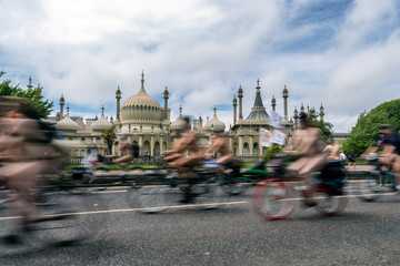 blurred naked cyclists going past brighton pavillion