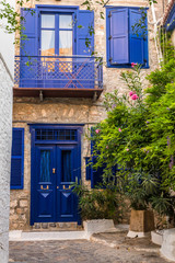 Entrance door with steps. Narrow traditional street in the town of Hydra, Hydra island, Greece
