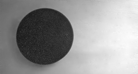 Black foam pad circle against white background and light gray color gradient, free space for text