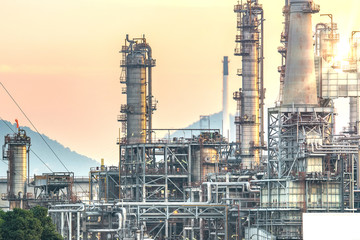 Oil and gas industrial refinery zone,Detail of equipment oil pipeline steel with valve from large oil storage tank at cloudy sky. -image