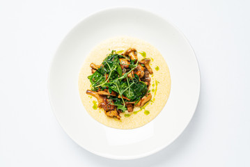 polenta with chanterelles on the white plate
