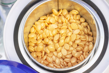 wax for depilation of a golden color in the apparatus for heating wax. view from above