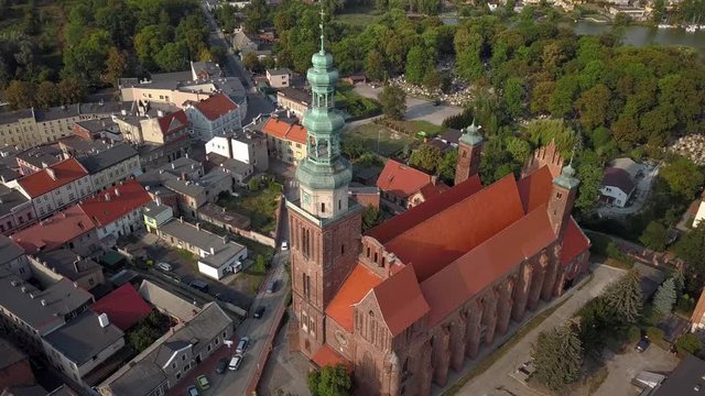 Aerial: Flight around the old medieval church in Chelmza, old city in Poland.
