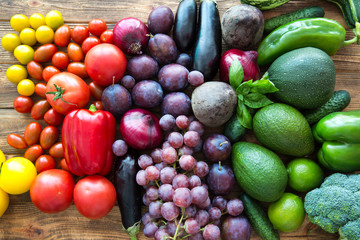A heap of vegetables and fruits from local market on brown wooden rustic background. Top view. Colorful autumn (fall) harvest. 