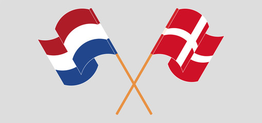 Crossed and waving flags of Netherlands and Denmark