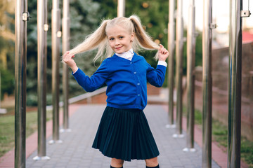Obraz premium Back to school and happy time. Cute child with blonde hair on isolated background. Girl ready to study. 