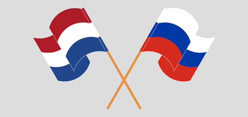 Crossed and waving flags of Netherlands and Russia
