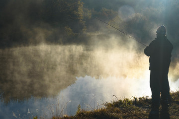 man catches fish on the river Snov in autumn, October 2018. Ukraine, the city of Chernigov