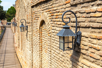 Old brick wall with cast iron lanterns