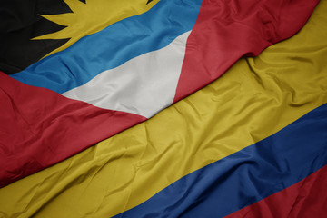 waving colorful flag of colombia and national flag of antigua and barbuda.