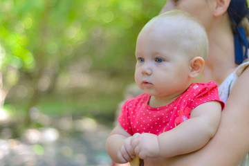 Portrait of a mother with a child in nature resting from the bustle of the city.