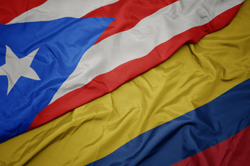 waving colorful flag of colombia and national flag of puerto rico.