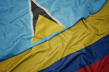 waving colorful flag of colombia and national flag of saint lucia