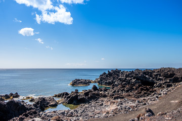 Fototapeta na wymiar Amazing landscape view to volcanic coastline near ocean hot springs natural pool of Ferraria (Piscina da Ponta da Ferraria), São Miguel Island, Azores, Portugal