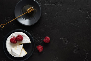 coffe, camembert, raspberries, honey on a dark backgraund minimalistic, breakfast