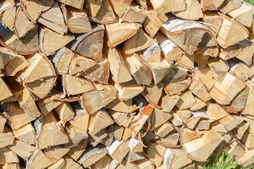 Dry chopped firewood lay in a pile on the street