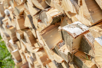 Dry chopped firewood lay in a pile on the street