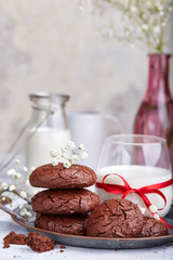 Chocolate brownie cookies served with glass of milk