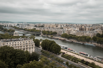 Fototapeta na wymiar Landscape aerial moody view of Seine river and cityscape in Paris, France on a cloudy day