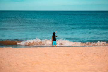 Child playing with sand on beach