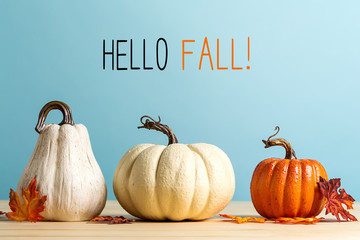 Hello fall message with pumpkins on a blue background