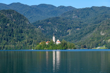 Fototapeta na wymiar Beautiful view of the island on Lake Bled with Pilgrimage Church of the Assumption of Maria.