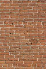 Old grungy red clay brick wall texture in common bond pattern, with deteriorating surface