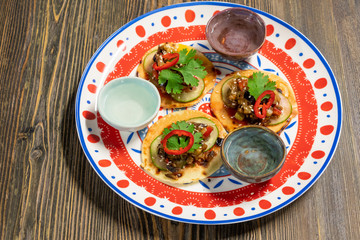 Mexican cuisine. Tacos and tequila on traditional plate