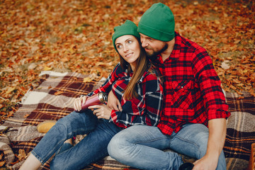 Couple in a park. Family in a golden forest. Man with a beard