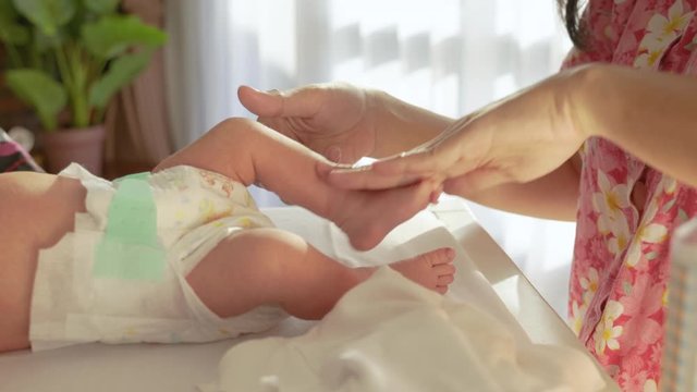 Little Newborn Baby Bath And Gentle Massage And Put Some Baby Oil