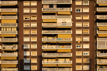 Municipal high-rise building with balconies at sunset