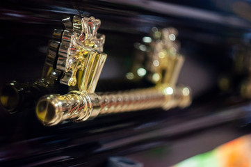 Fototapeta premium closeup shot of a colorful casket in a hearse or chapel before funeral or burial at cemetery