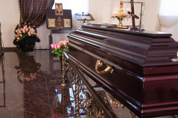 closeup shot of a colorful casket in a hearse or chapel before funeral or burial at cemetery