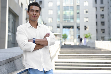 Handsome young African-American man on city street. Space for text