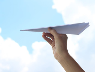 plane paper in hand and cloudy day. 