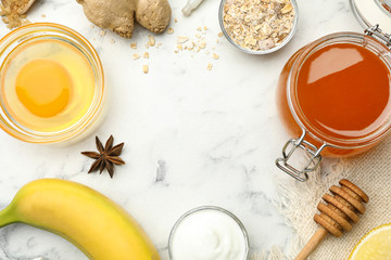 Frame of different ingredients with space for text on white marble background, flat lay. Handmade face mask