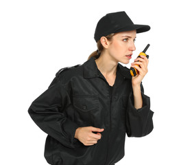 Female security guard in uniform using portable radio transmitter on white background