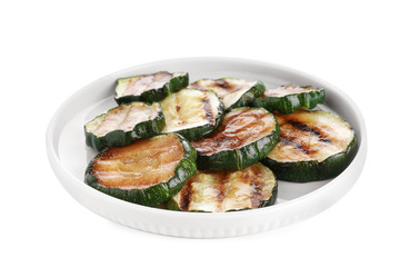 Plate of delicious grilled zucchini slices on white background