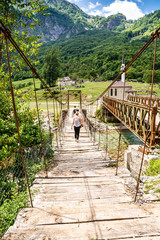 Obraz premium Old bridge in Dragobi over river Lumi i Valbones National Park Valbona in Albania, Europe