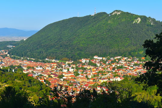 Brasov with its many tourist attractions including churches, town squares, traditional old houses, clock towers and markets for local produce at the foot of Tampa mountain. Brasov, Romania, Balkans