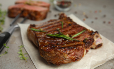 Grilled meat steak on grey table, closeup