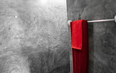 One red towel in bathroom on a dryer. Counter bathroom interior contemporary. Luxury and stylish design bathroom with a concrete style walls.