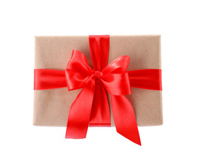 Christmas gift box decorated with ribbon bow on white background, top view