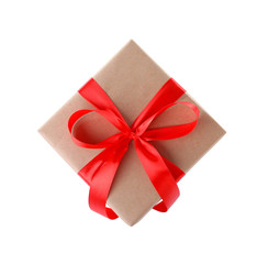 Christmas gift box decorated with ribbon bow on white background, top view