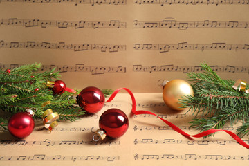 Composition with Christmas decorations on music sheets